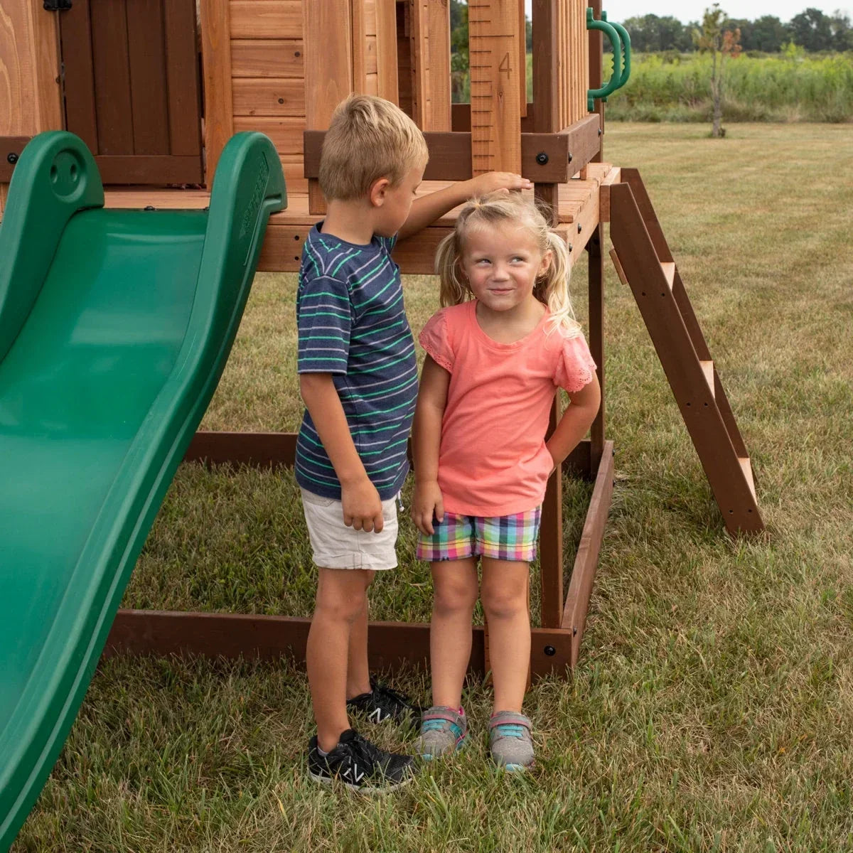 Backyard Discovery Echo Heights Cedar Wooden Elevated Kids Playhouse with Wave Slide, Play Kitchen, and Deck